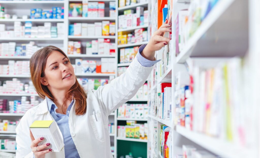 Should I Go To The Pharmacy Or GP? | Broadgate GP pharmacist restocking shelves in chemist