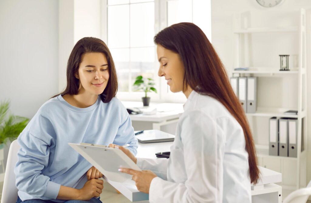 private gp examining female patient