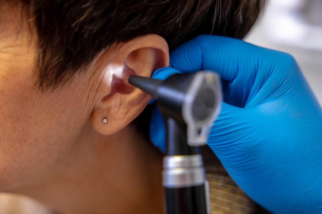ENT doctor examining an elderly female patient