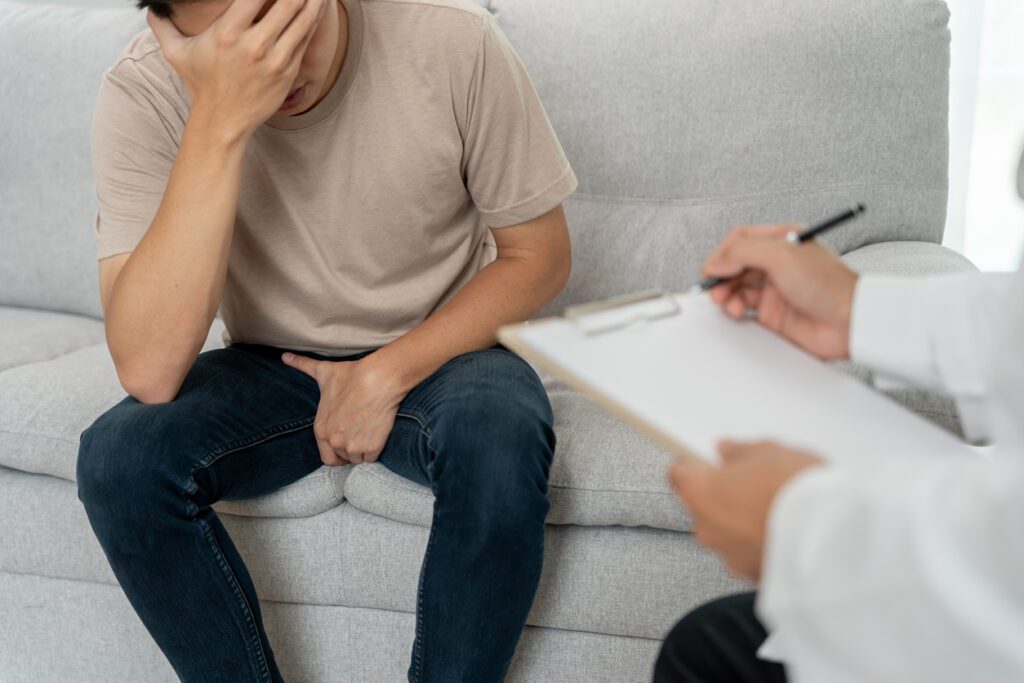 Man hold hand in front of private parts feeling discomfort and consult doctor. Venereal, testicular cancer. bladder problems, erectile dysfunction, premature ejaculation, prostate cancer