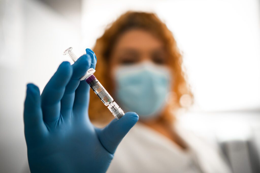Female doctor showing vaccine