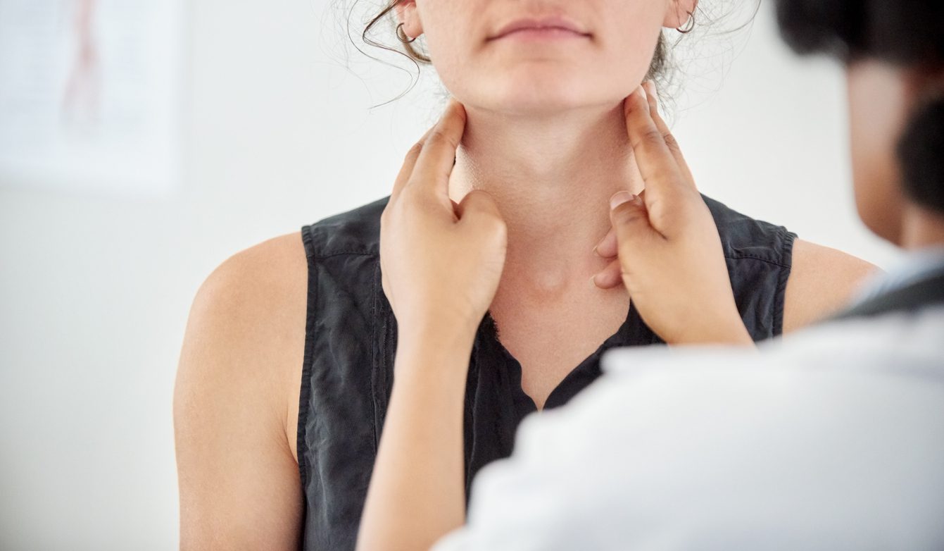 Tonsil Stones vs Tonsillitis: Symptoms, Treatment and When to Worry | Broadgate GP Doctor checking thyroid of a young patient in clinic